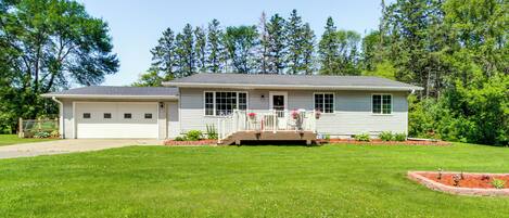 A single-story house with a front porch, a garage, and a well-maintained lawn.
