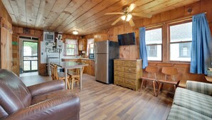 A cabin interior with a kitchen, dining area, and seating. - Complimentary Boat Rentals! Lake Huron Cabin (Cedarville)