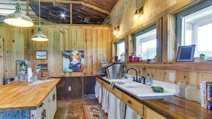 A rustic kitchen with wooden walls, a wooden countertop, a sink, and a window. - BBQ Ready: Farm-style Kinston Hideaway w/ Pool (Samson)