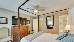 A bedroom with a four-poster bed, a wooden dresser, a chair, a ceiling fan, and a mirror. - Gastonia Family Home < 20 Mi to Crowders Mtn (Gastonia)