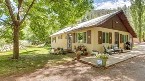 A rustic cabin with a porch, outdoor seating, and a hammock. - Hike On-site: Mountain-view Hideaway in Durango (Durango)