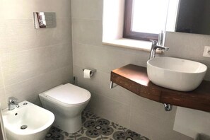A small bathroom with a toilet, bidet, and sink. - Maripetra B&B (Sangineto)