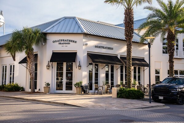 A two-story building with the sign 'GOATFEATHERS SEAFOOD' and a black awning over the entrance.