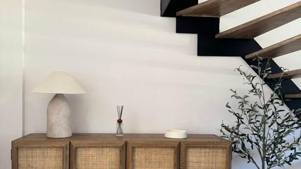 A wooden console with woven panels, a lamp, and a vase with a plant. - Gite 2 in the heart of the countryside (Chimay)