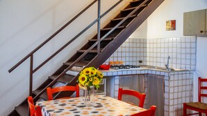 A kitchen with a tiled backsplash, a sink, and a stove.