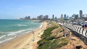 A coastal cityscape with a beach, promenade, and modern buildings. - 1604 Tel aviv (Tel Aviv)