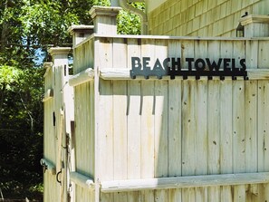 A wooden structure with the words "BEACH TOWELS" on it.