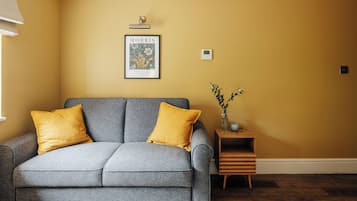 Family Suite, 1 King Bed with Sofa bed, Air conditioning | Living area | 32-inch Smart TV with digital channels