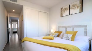 A hotel room with a bed, a nightstand, and a wall-mounted artwork. - Lorandalou - Two Bedroom Apartment, Sleeps 4 (San Juan de los Terreros)