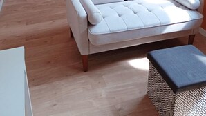 A modern bedroom with a bed, a sofa, and a small table. - Studio L'with terrace (Oyonnax)