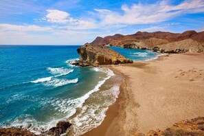 A coastal landscape with a sandy beach, rocky outcrops, and a clear blue sky. - Casa Floor - Two Bedroom Apartment, Sleeps 4 (Pulpí)