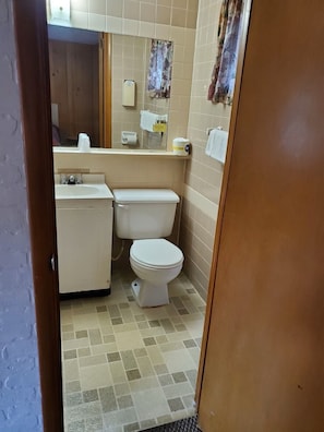 A small bathroom with a toilet, sink, and mirror. - Economy Double Room, 2 Double Beds #13 (Hart)