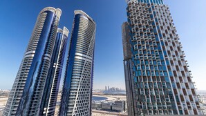 Three high-rise buildings with a clear view of the surrounding cityscape.