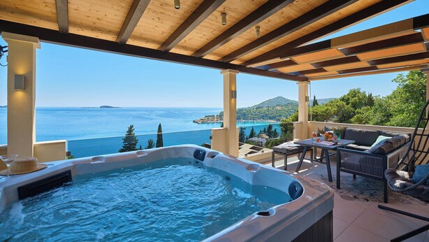 A hot tub with a view of the sea, wooden ceiling beams, and outdoor seating. - Hedera Estate, Hedera A54 (Mlini)