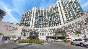 A modern high-rise building with a prominent entrance and a sign reading "FARHAD AZIZI RESIDENCE". - Lux BnB Farhad Azizi- Al Jaddaf  (Dubai)