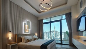 A modern hotel room with a large bed, a city view, and a TV on the wall. - Lux BnB Farhad Azizi- Al Jaddaf  (Dubai)