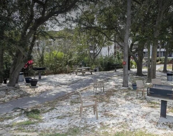 A park with benches, trees, and a picnic table. - Island Escape, Beach view Condo at Hilton Head Beach & Tennis Resort (Hilton Head)