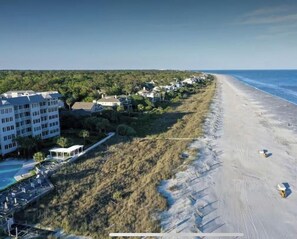 A coastal hotel with a beach view, a pool, and a road leading to the beach. - Island Escape, Beach view Condo at Hilton Head Beach & Tennis Resort (Hilton Head)