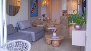 A modern living room with a sofa, chairs, a coffee table, and a dining area. - Relax in front of the sea (Cartagena de Indias)