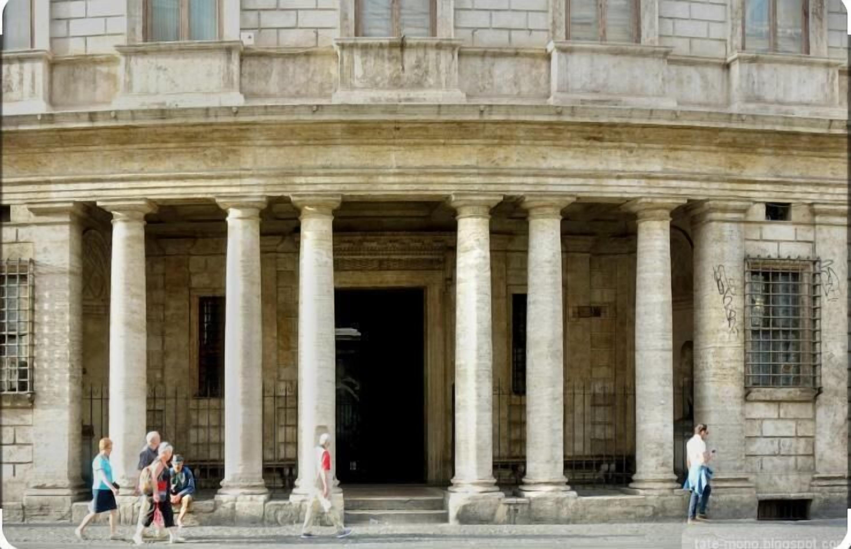 A building with a classical architectural style, featuring a series of columns and a large entrance.