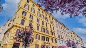 A yellow building with multiple windows and a sign that reads "Del Frate".