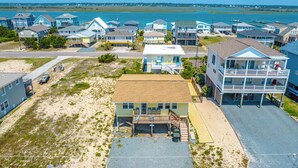 A coastal residential area with houses, a beach, and a marina. - Mountains to Sea by Topsail Realty (Holly Ridge)