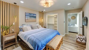 A bedroom with a bed, bedside table, and a bedside lamp. - Coastal Getaway w/HotTub in La Marque! (La Marque)