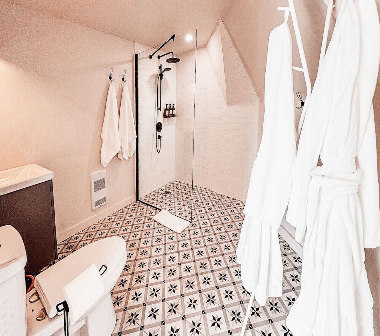 A modern bathroom with a shower, a bathtub, and a toilet.