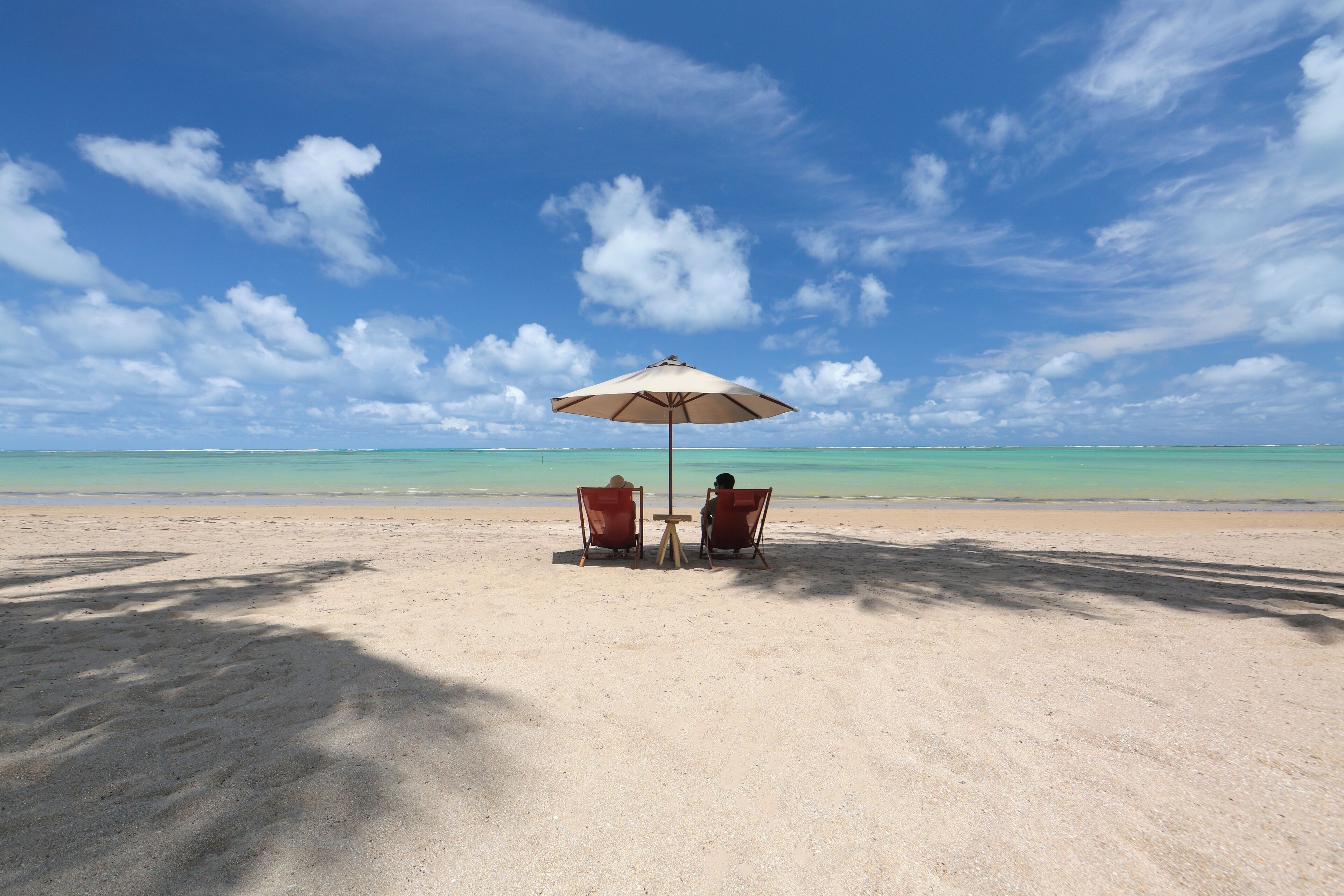 Na praia, guarda-sóis, toalhas de praia, massagens na praia 