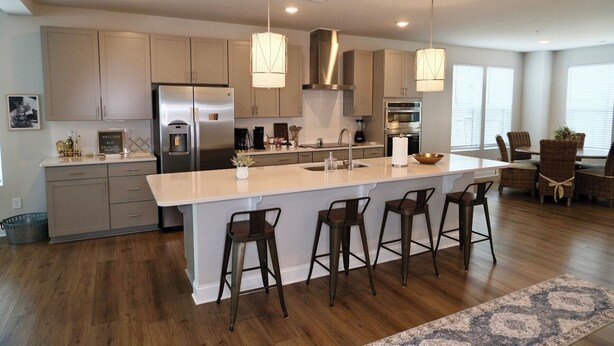 A modern kitchen with a large island, stainless steel appliances, and pendant lighting. - Brand New! Huge 3-bedroom, 2,500 sqft  3rd and 4th floor condo, private rooftop. (Raleigh)