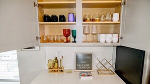A minibar with various glassware and a sign indicating WiFi availability. - Brand New! Huge 3-bedroom, 2,500 sqft  3rd and 4th floor condo, private rooftop. (Raleigh)