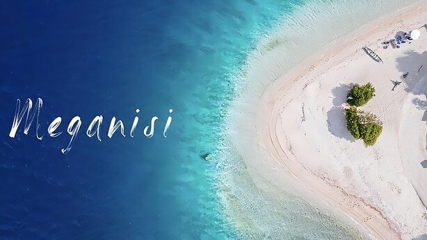 An aerial view of a beach with the word "Meganisi" overlaid.