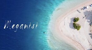 An aerial view of a beach with the word "Meganisi" overlaid. - 8 Homes  (Meganisi)