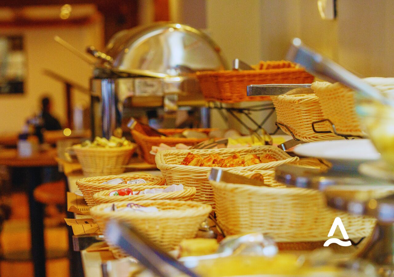A buffet with various food items in wicker baskets.