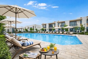 4 outdoor pools, open 9:00 AM to 9:00 PM, pool umbrellas, pool loungers