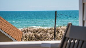 A beach view with a wooden structure and a utility pole. - Skipper's Hideout by Topsail Realty (Sneads Ferry)