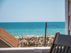 A beach view with a wooden structure and a utility pole. - Skipper's Hideout by Topsail Realty (Sneads Ferry)