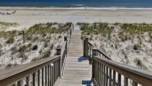 A wooden boardwalk leading to a beach with dunes and the ocean in the background. - Sunny Side Up by Topsail Realty (Sneads Ferry)