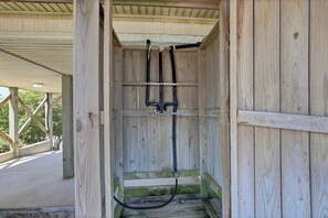 A wooden structure with a metal frame and a hose. - You're The Tops by Topsail Realty (Holly Ridge)