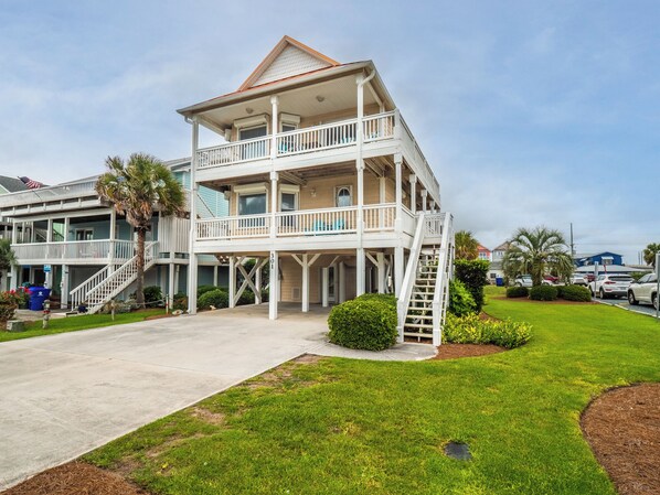 A two-story beachfront building with a balcony, a staircase, and a well-maintained lawn. - Beach, Please by Topsail Realty (Holly Ridge)