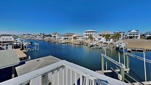 A marina with multiple docks and boats, surrounded by waterfront houses. - Bellcove by Topsail Realty (Holly Ridge)