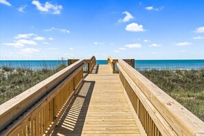 A wooden boardwalk leading to a beach with clear skies. -   New Construction!!! Sleeps 7! Short drive to Sunset &Ocean Isle Beach / Golf!! (Sunset Beach)