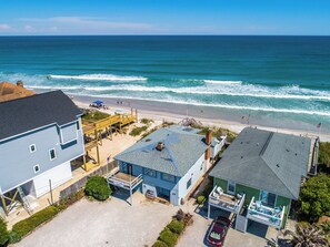 A coastal property with a beach view, a dock, and a small boat. - S.O.B. (Sweet Ol' Bill) by Topsail Realty (Holly Ridge)