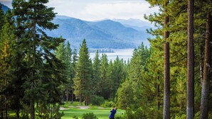 A golf course with a view of mountains and a lake. - Charming 3-bedroom Ski Cabin on Golf Course in lovely Incline Village (Incline Village)