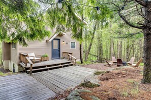 A cabin with a wooden deck, outdoor seating, and a door with a small porch. - Lake Access at Family-Friendly Home in Tobyhanna (Tobyhanna)