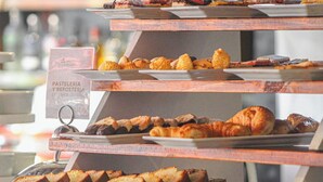 A bakery display with various pastries and bread.