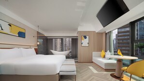 A modern hotel room with a bed, a bathtub, a sofa, a dining table, and a TV. - voco Chengdu Chunxi Road by IHG (Chengdu)
