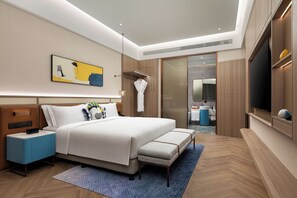 A modern hotel room with a large bed, bedside tables, a TV, and a bathroom visible through an open door. - voco Chengdu Chunxi Road by IHG (Chengdu)