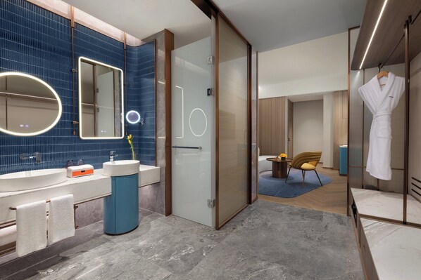 A modern bathroom with a large mirror, a round mirror, and a vanity with a sink. - voco Chengdu Chunxi Road by IHG (Chengdu)