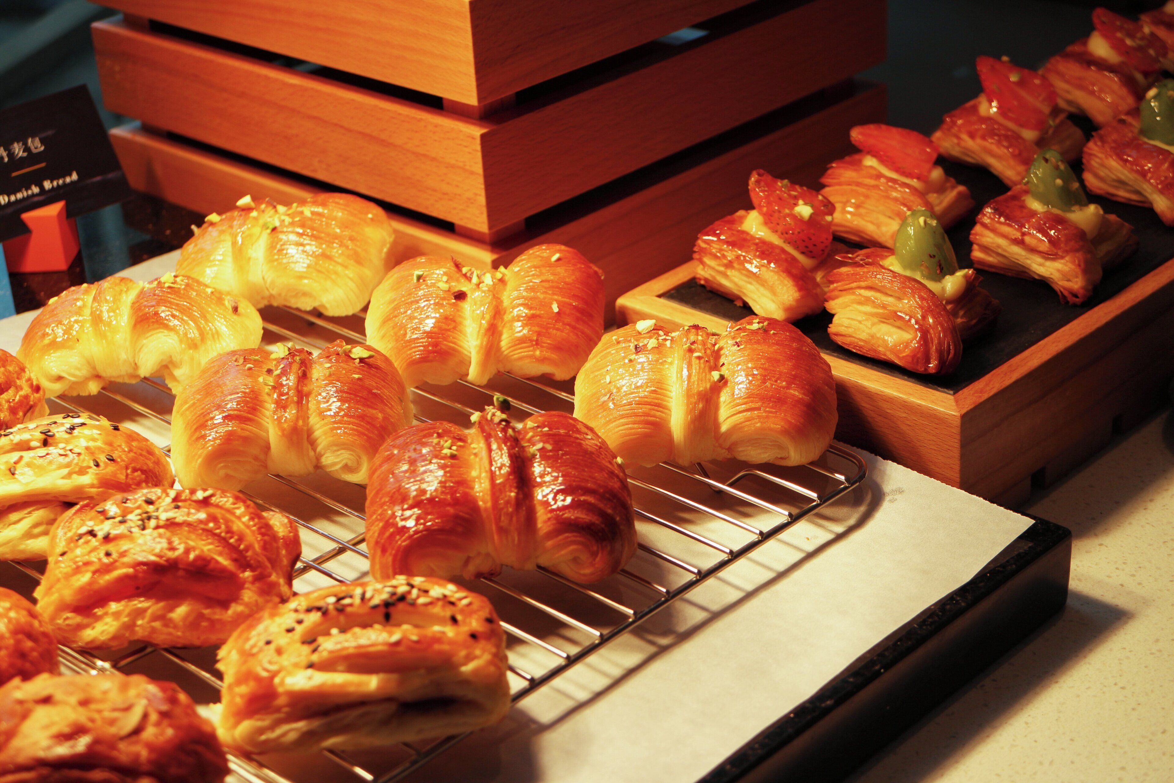 An assortment of pastries displayed on a wooden rack.